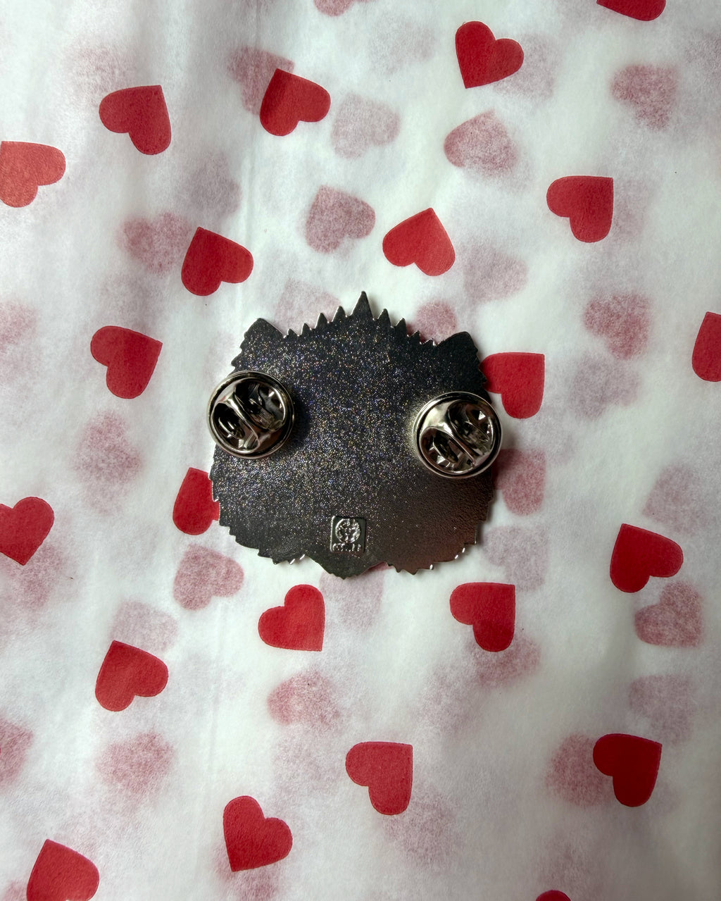 This is an Outrage Enamel Pin