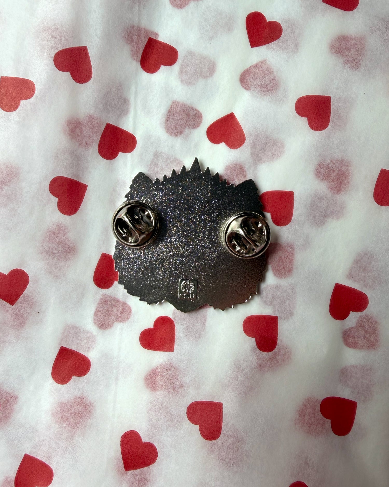 This is an Outrage Enamel Pin