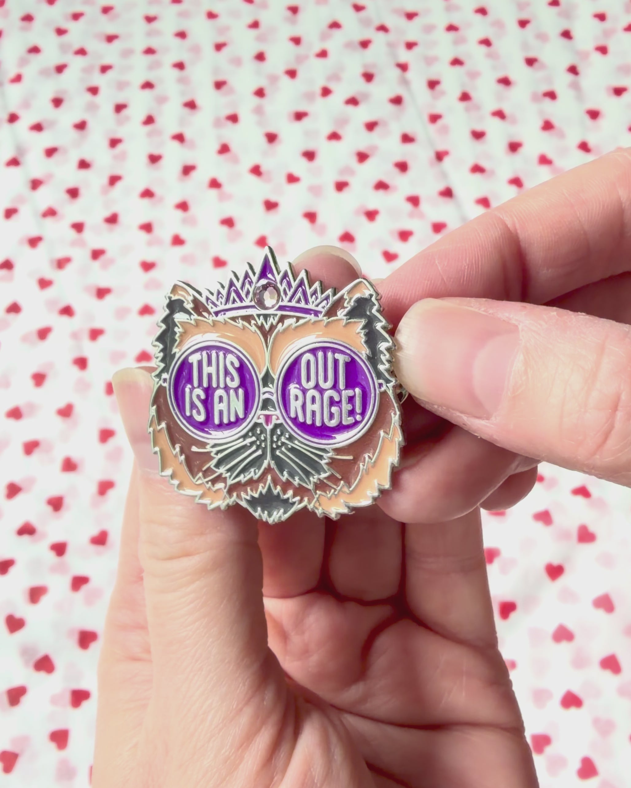 This is an Outrage Enamel Pin